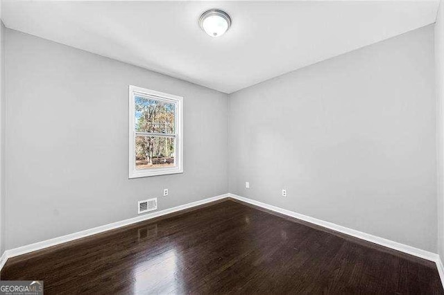 spare room with hardwood / wood-style flooring