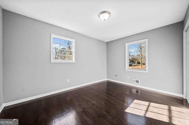 unfurnished room with a wealth of natural light and wood-type flooring