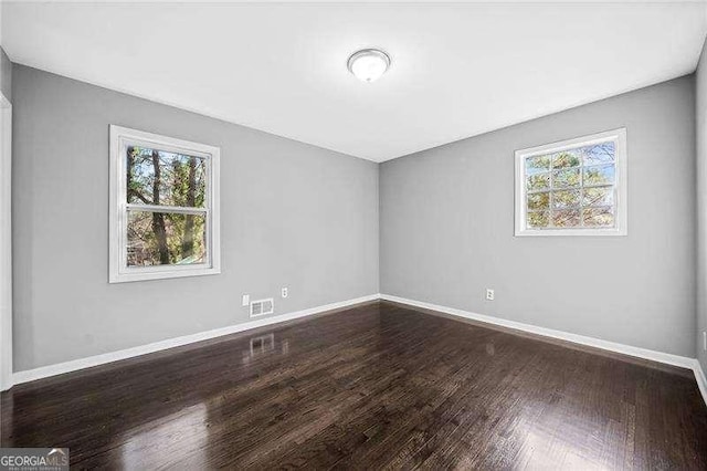 unfurnished room featuring hardwood / wood-style flooring