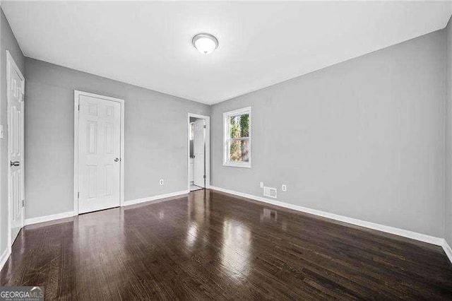 unfurnished bedroom featuring dark hardwood / wood-style floors