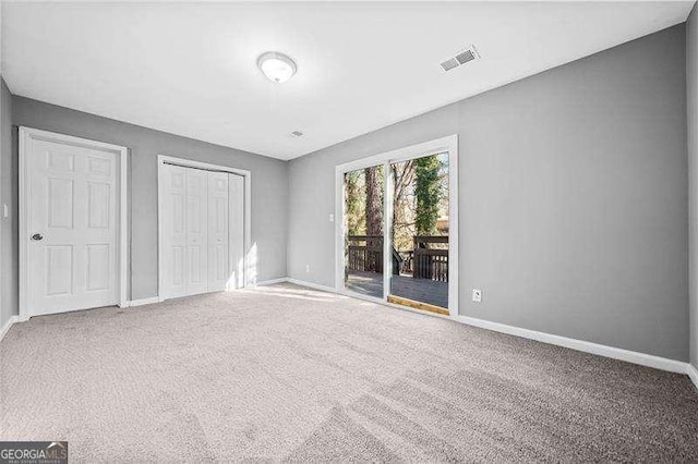 unfurnished bedroom featuring carpet, access to outside, and a closet