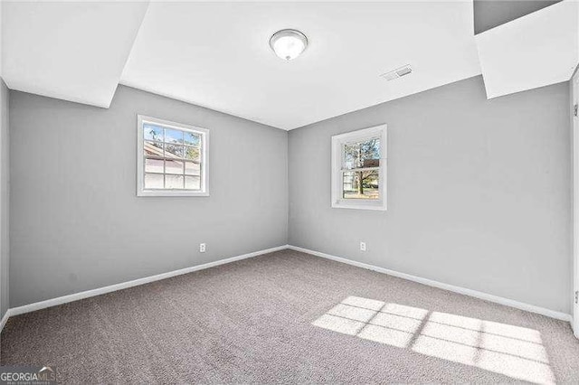 carpeted empty room featuring a healthy amount of sunlight