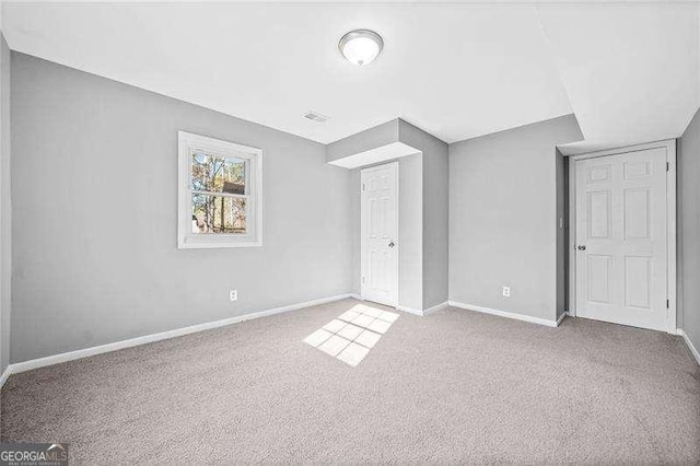 unfurnished bedroom featuring light carpet