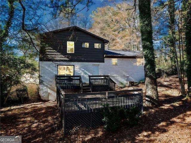 rear view of house with a wooden deck