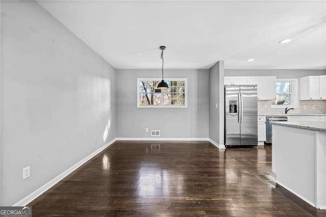 unfurnished dining area with dark hardwood / wood-style flooring and sink