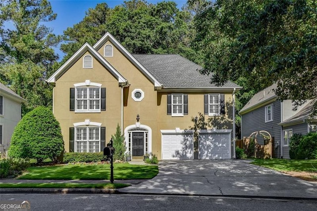 view of front of property featuring a garage and a front lawn