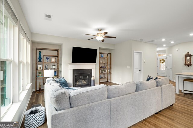 living room with hardwood / wood-style floors and ceiling fan