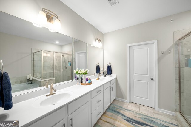 bathroom featuring vanity, tile patterned floors, and a shower with shower door