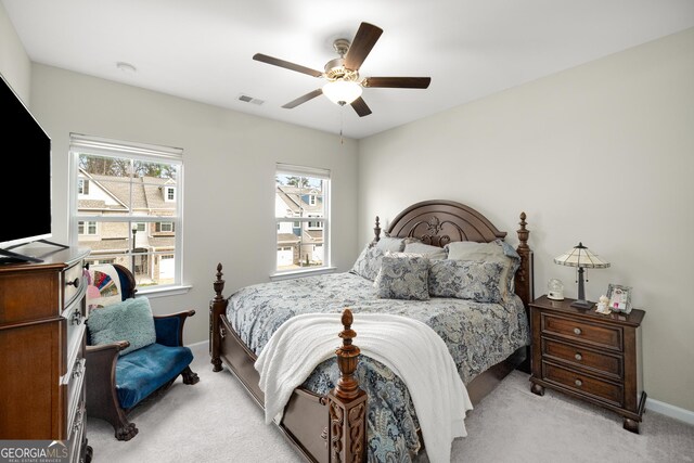 bedroom with ceiling fan and light carpet