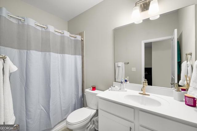 bathroom with vanity, toilet, and a shower with shower curtain