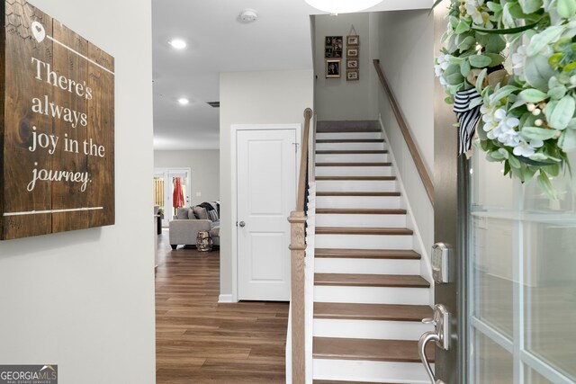 stairway with hardwood / wood-style flooring