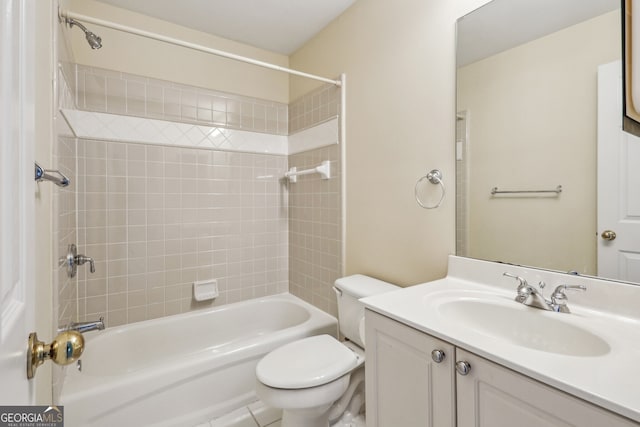 full bathroom with tiled shower / bath combo, vanity, and toilet