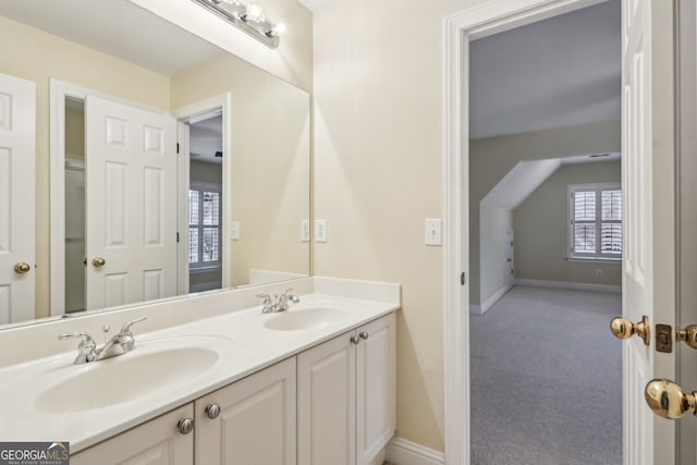 bathroom featuring vanity and lofted ceiling