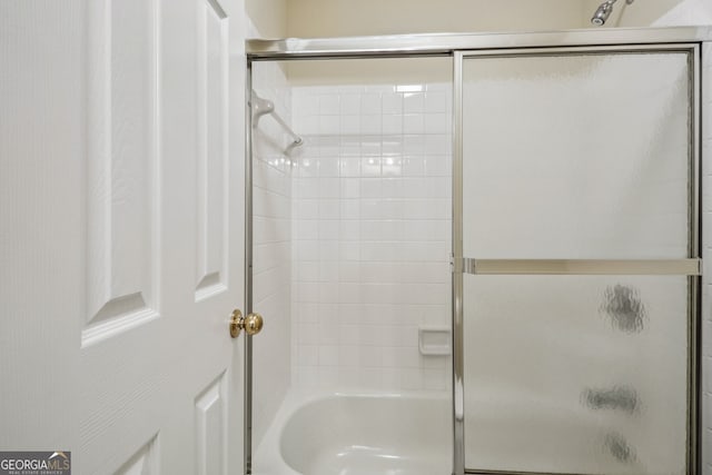 bathroom featuring shower / bath combination with glass door