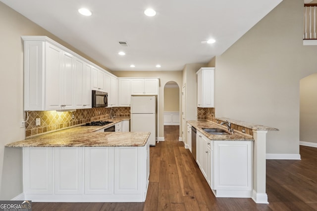 kitchen featuring sink, white cabinetry, kitchen peninsula, light stone countertops, and black appliances