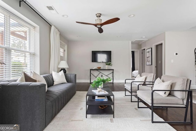 living room featuring ceiling fan and light hardwood / wood-style floors