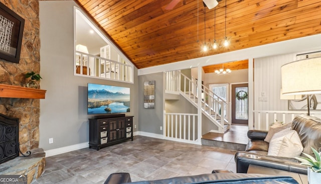 living room with high vaulted ceiling, a notable chandelier, a fireplace, and wooden ceiling