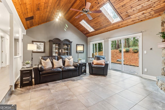 tiled living room featuring high vaulted ceiling, a skylight, wooden ceiling, and ceiling fan