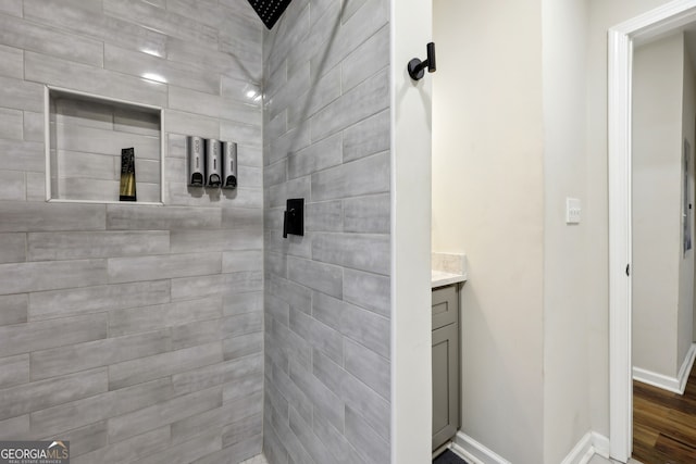 bathroom with vanity and tiled shower