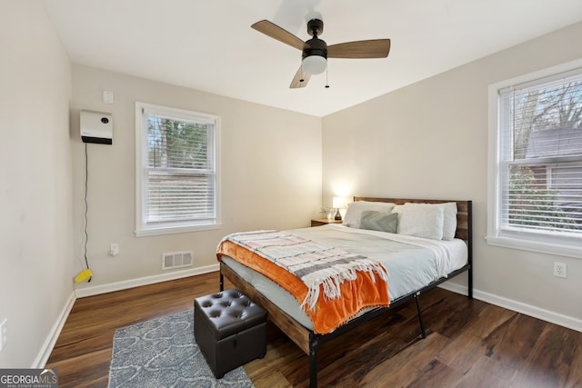 bedroom with ceiling fan and dark hardwood / wood-style flooring