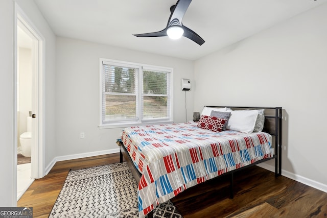 bedroom featuring ceiling fan, dark hardwood / wood-style floors, and an AC wall unit