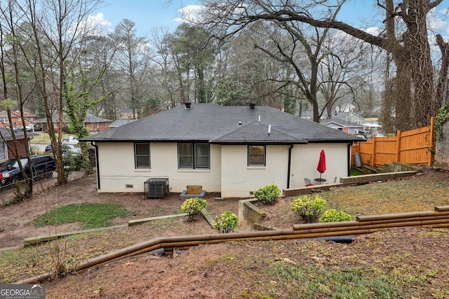 rear view of property with central AC unit