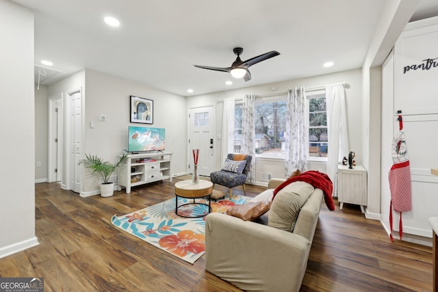 living room with dark hardwood / wood-style floors, radiator, and ceiling fan