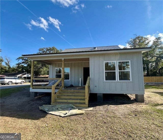 view of front of property with metal roof, a porch, and board and batten siding