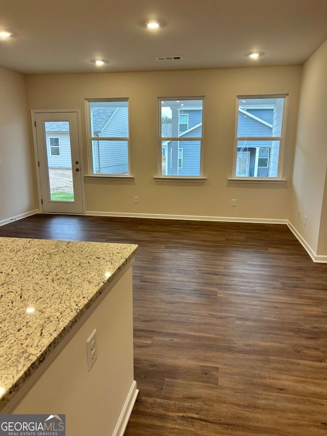 16 Wildflower Ln Unit 39, Dallas, GA 30132 - unfurnished living room featuring plenty of natural light, dark wood-style flooring, and recessed lighting