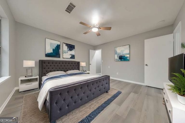 bedroom with hardwood / wood-style floors and ceiling fan