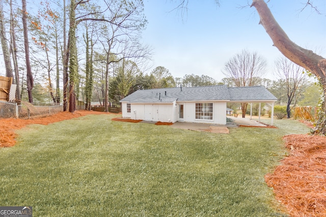 back of property featuring a patio area and a lawn