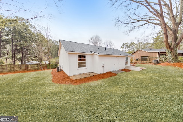 back of property featuring a yard, central AC, and a patio area