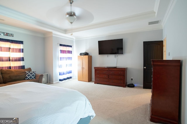 bedroom featuring ceiling fan, ornamental molding, a raised ceiling, and light carpet