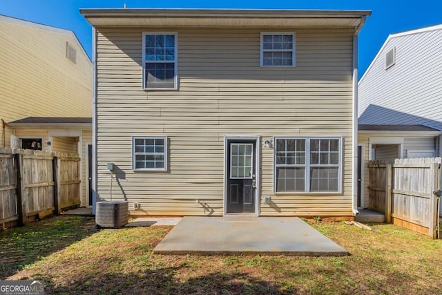 rear view of house with central AC unit, a patio area, and a lawn