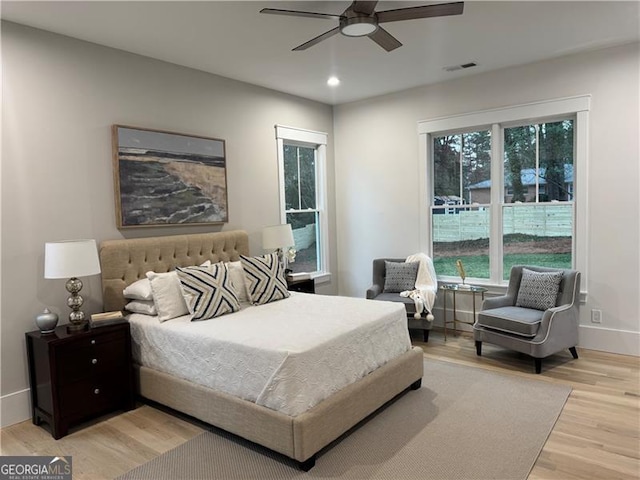 bedroom with light hardwood / wood-style flooring and ceiling fan