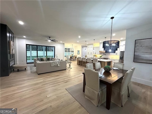 dining space featuring ceiling fan and light wood-type flooring