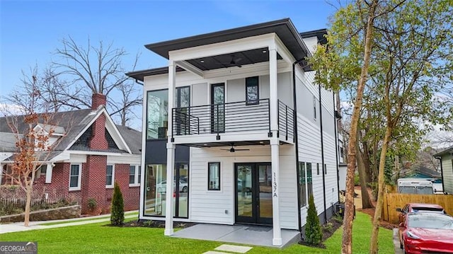 modern home with ceiling fan, a balcony, a patio area, and a front yard