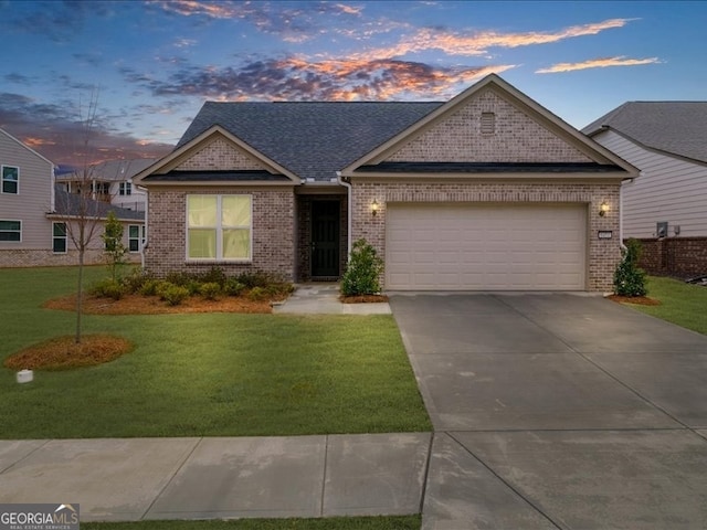 view of front of house featuring concrete driveway, a front lawn, an attached garage, and brick siding