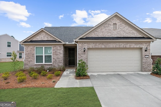 view of front of property featuring a garage, a front yard, concrete driveway, and brick siding