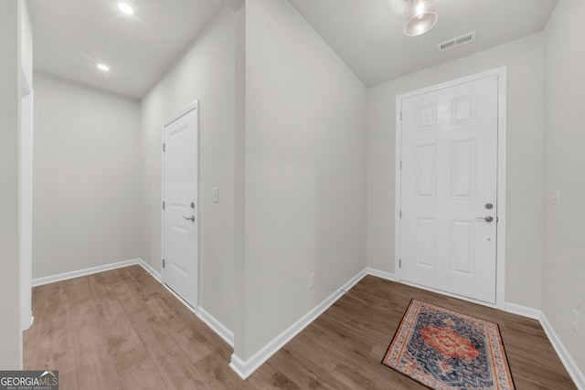 entryway featuring visible vents, baseboards, and wood finished floors