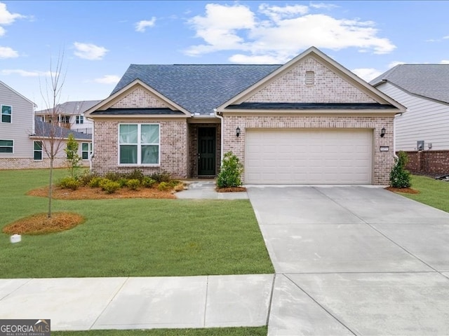 view of front of house with an attached garage, brick siding, driveway, roof with shingles, and a front yard