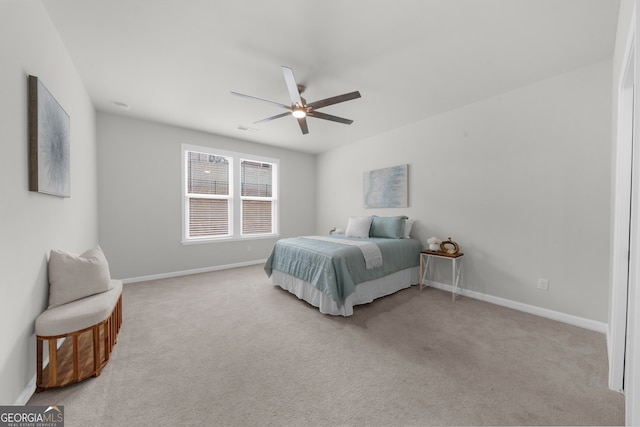 carpeted bedroom featuring ceiling fan, visible vents, and baseboards