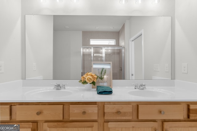 full bathroom with double vanity, a stall shower, and a sink