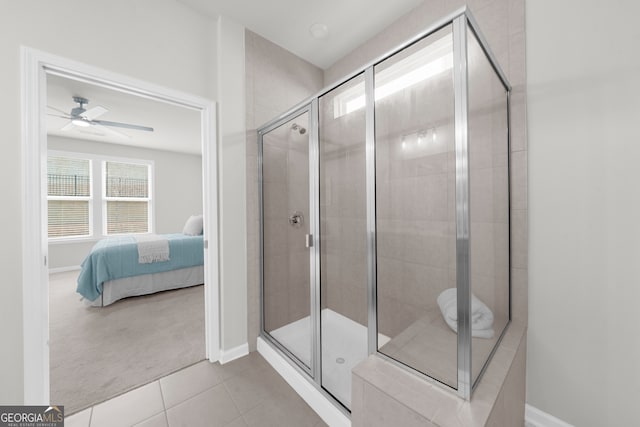 bathroom featuring connected bathroom, tile patterned flooring, plenty of natural light, and a shower stall