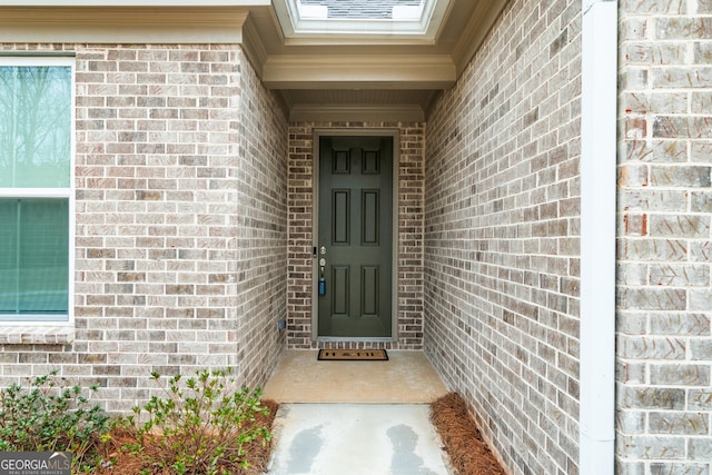 entrance to property with brick siding