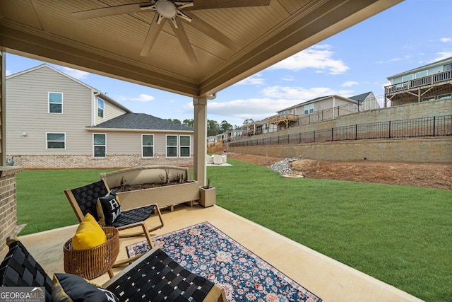 view of patio with fence, outdoor lounge area, and a ceiling fan