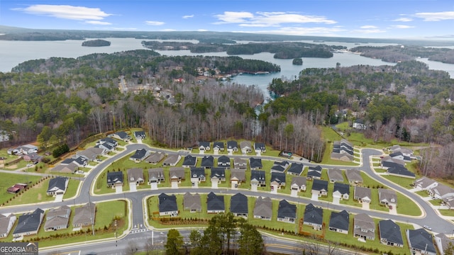 birds eye view of property featuring a water view, a residential view, and a view of trees