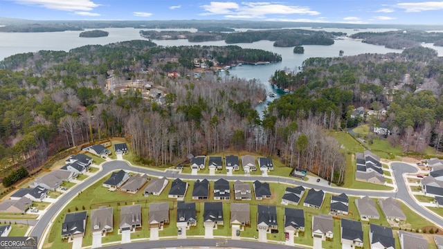 bird's eye view featuring a forest view, a water view, and a residential view