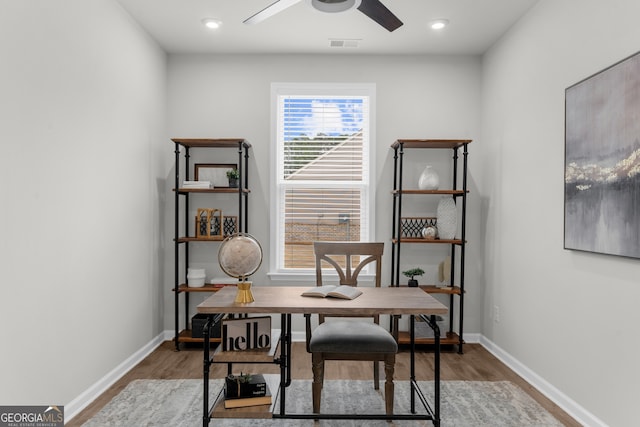 office area with visible vents, ceiling fan, baseboards, and wood finished floors