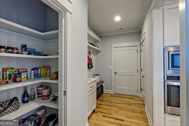 mudroom with light hardwood / wood-style flooring